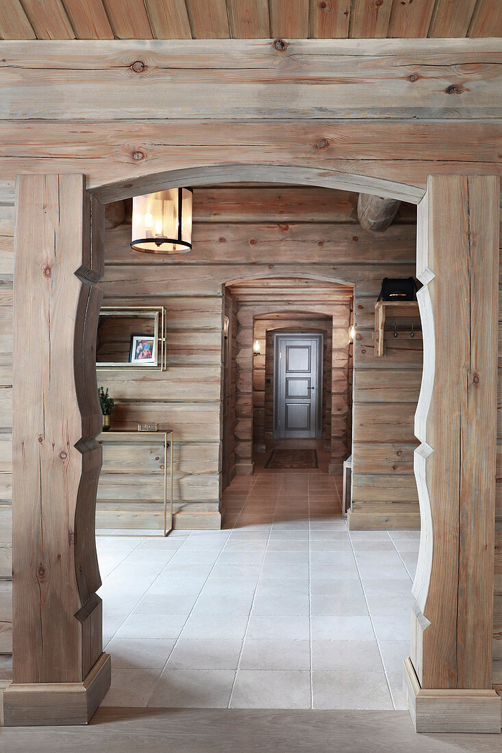 Traditional open doorway leading into hallway of log cabin