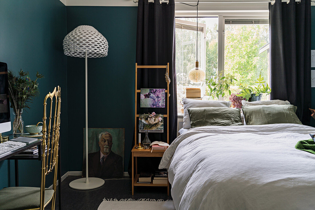 Mystical colour scheme in bedroom with deep teal walls