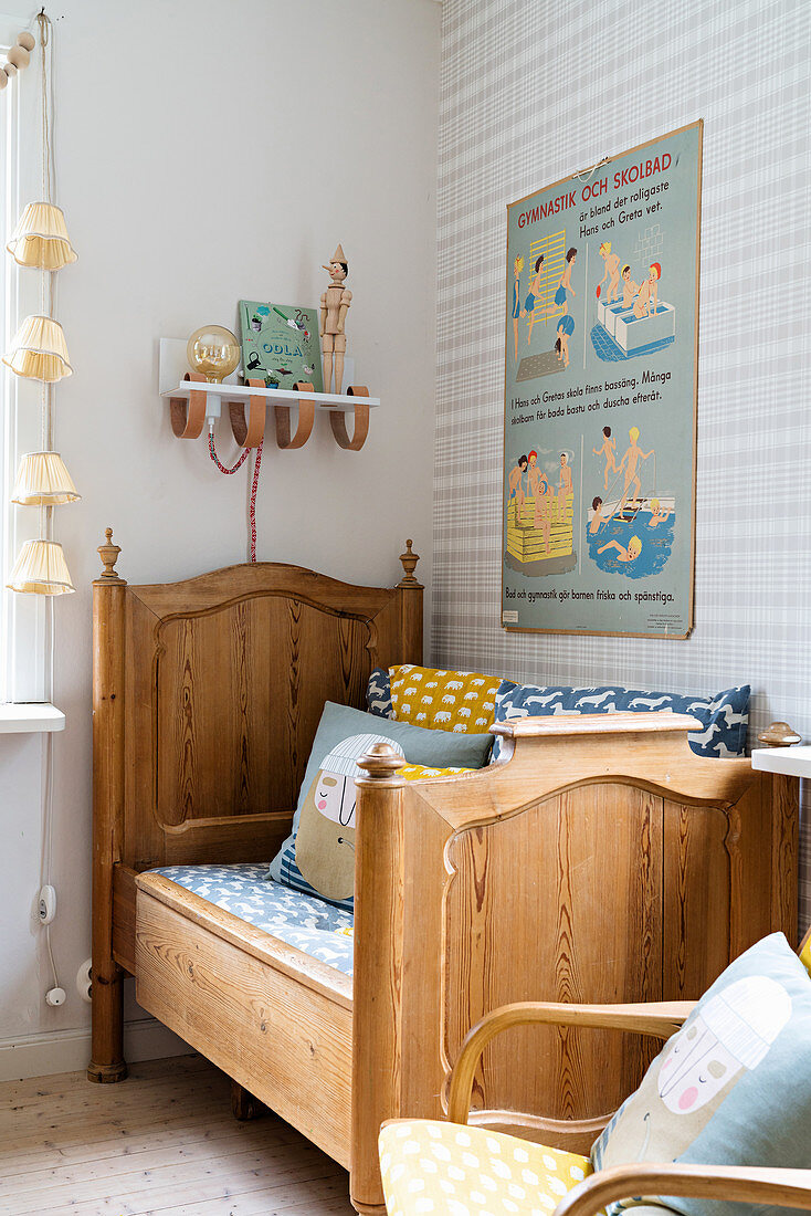 Wooden bed and patterned wallpaper in nursery