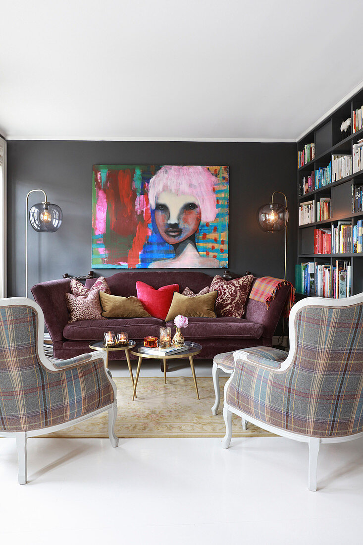 Sofa, tartan armchairs and huge portrait of woman in eclectic living room