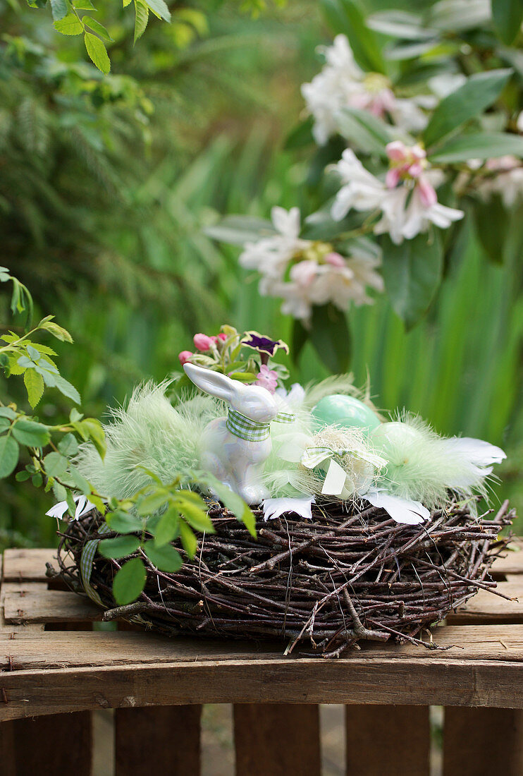 Easter bunny in the Easter basket with feathers