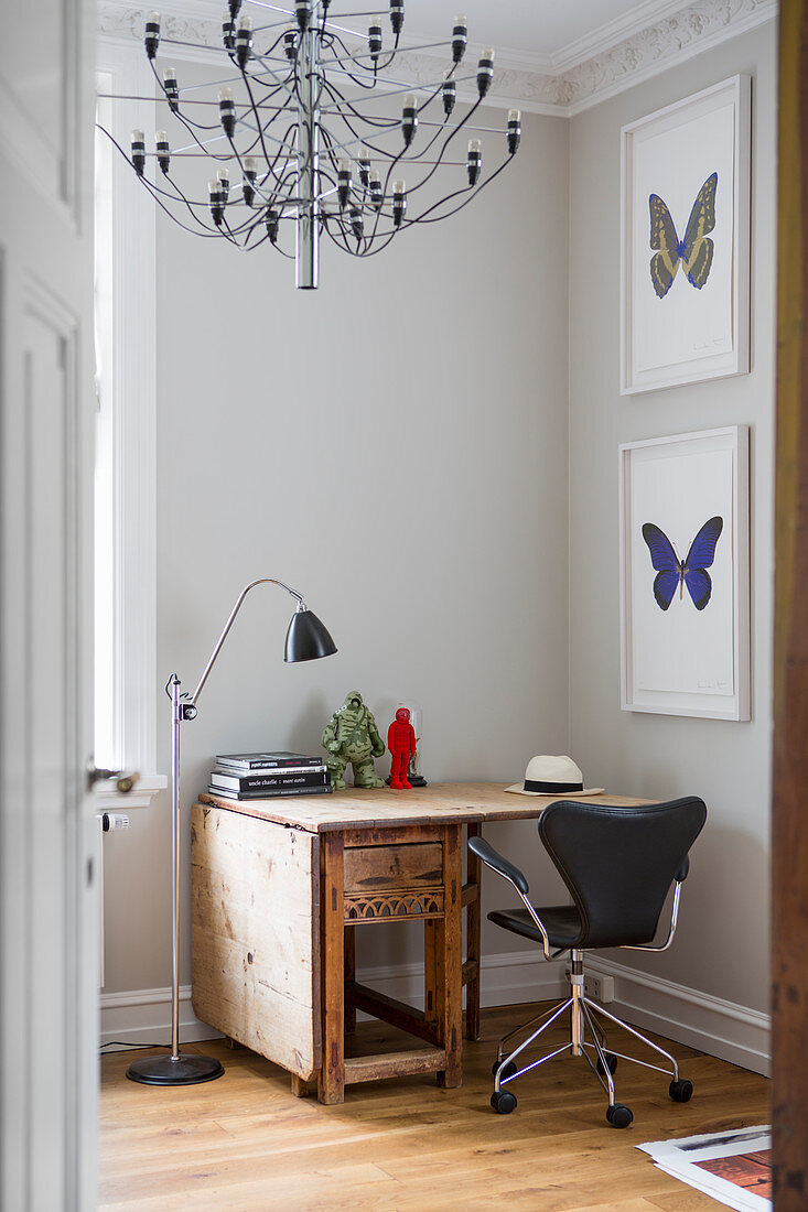 Drop-leaf table and pictures of butterflies in study in period apartment