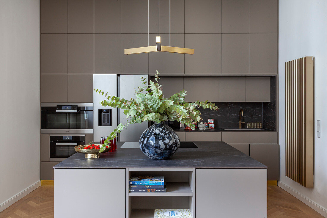 Vase of eucalyptus in grey modern kitchen