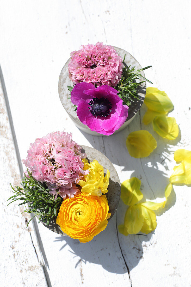 Spring flowers in handmade concrete vases
