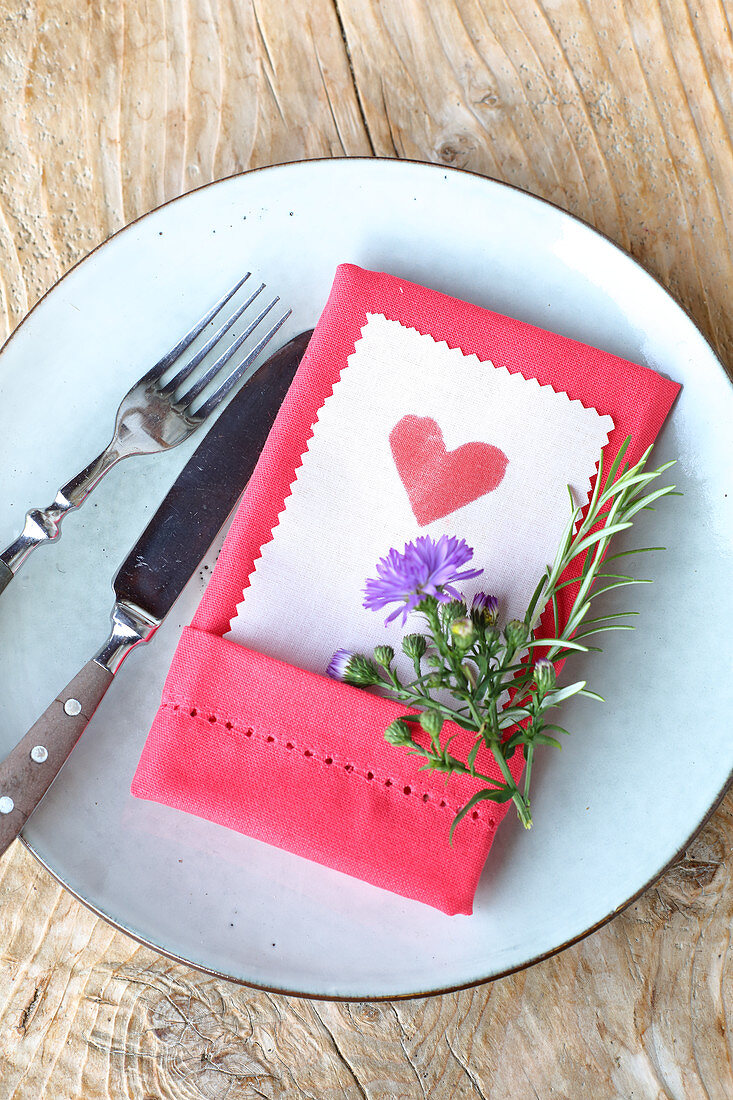 Heart printed on paper with pinked edge tucked into linen napkin