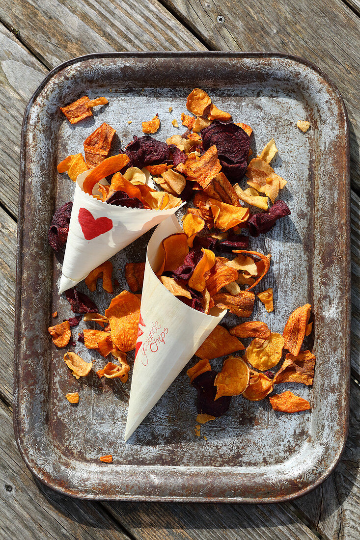 Handmade crisps made from colourful potatoes in paper cones