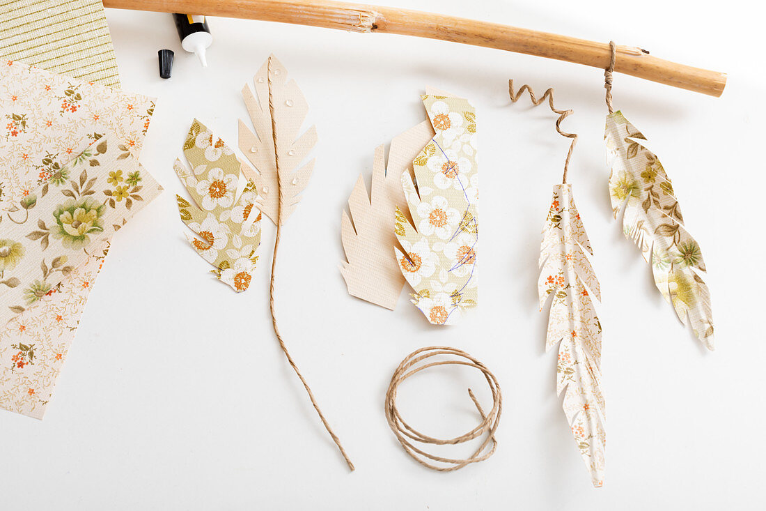 Steps for making a garland of feathers from wallpaper remnants