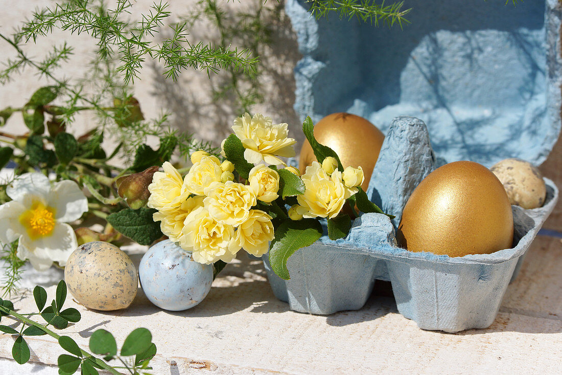 Easter eggs, primulas and rose branches
