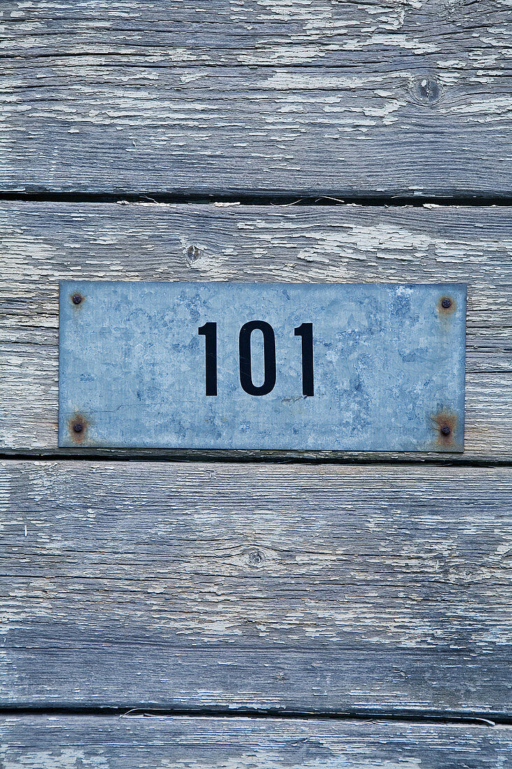 Zinc plate with number 101 on board wall