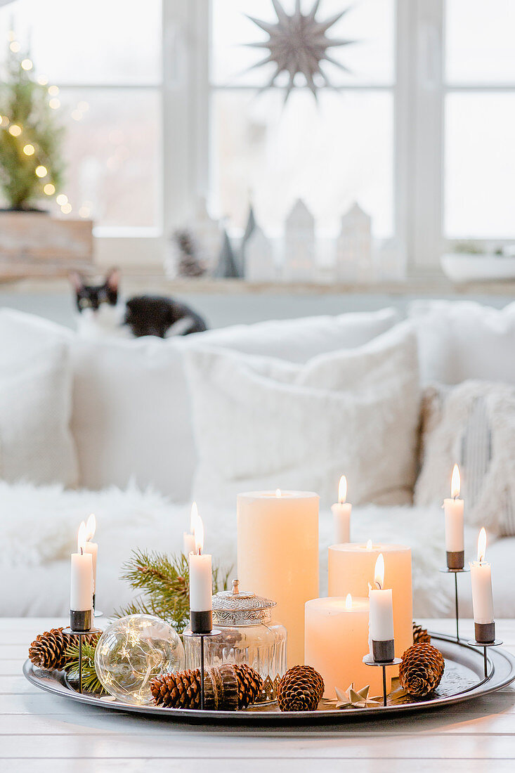 Kranz aus Kerzen auf einem Tablett mit Weihnachtsdeko im Wohnzimmer