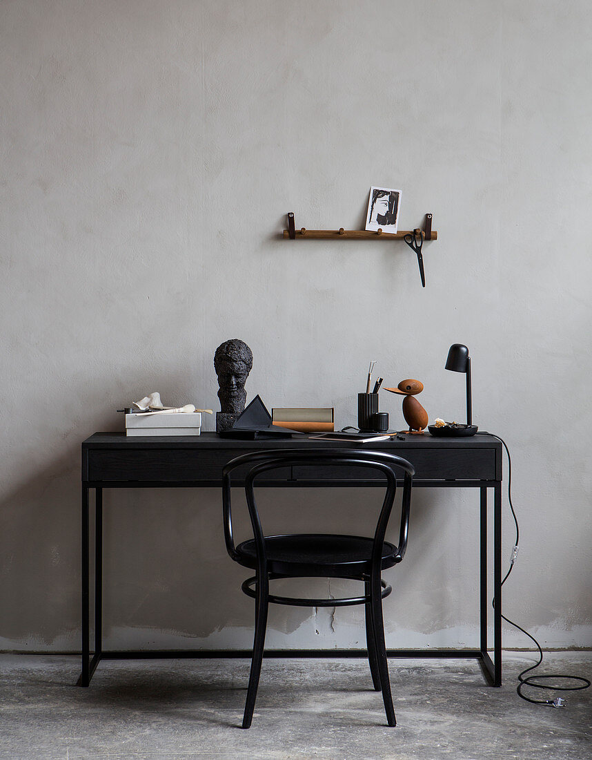 Schwarzer Kaffeehausstuhl am Schreibtisch mit Vintage-Deko