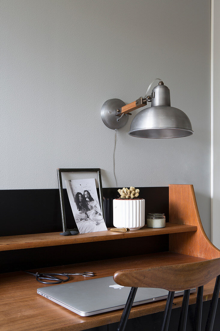 Vintage, wall-mounted lamps above mid-century desk