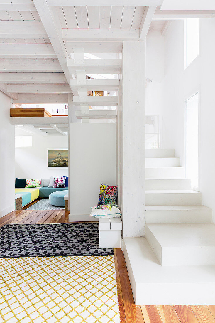 White staircase in open-plan interior