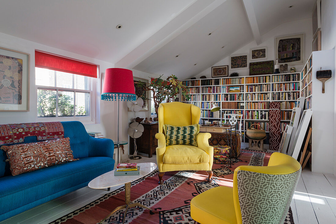 Gelbe und blaue Polstermöbel im bunten kleinen Wohnzimmer