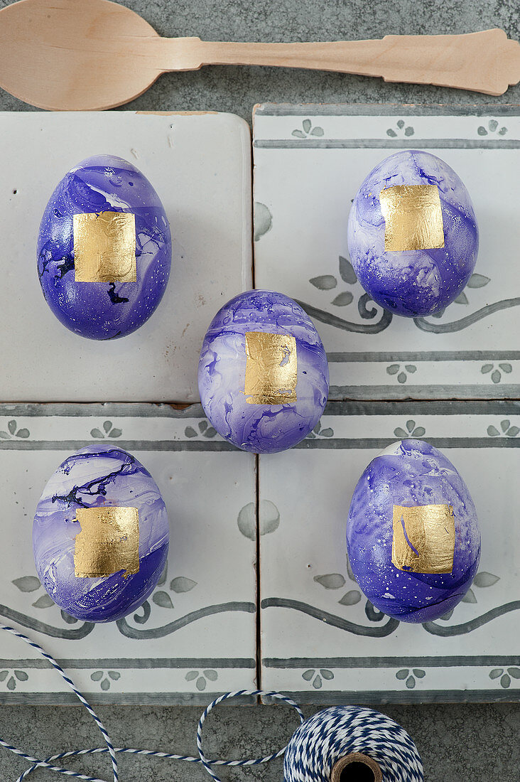 Purple marbled Easter eggs decorated with gold leaf