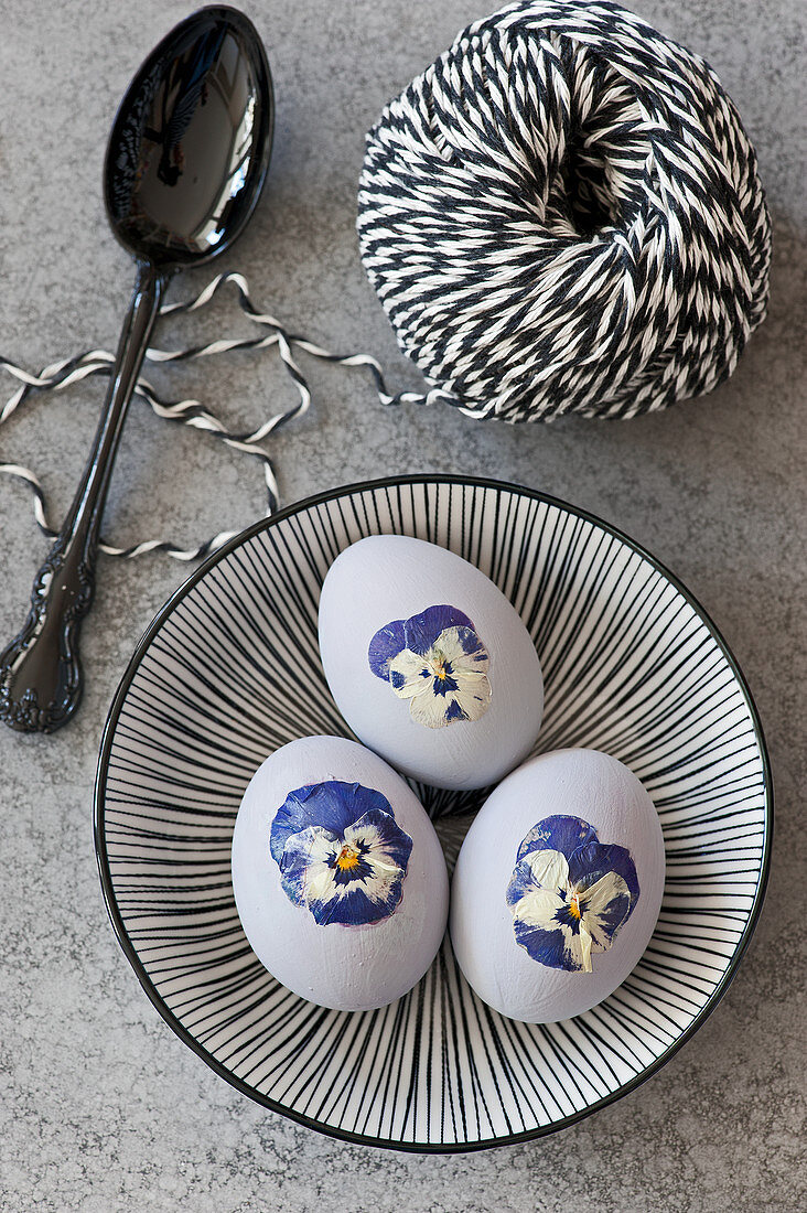 Easter eggs decorated with pressed violas