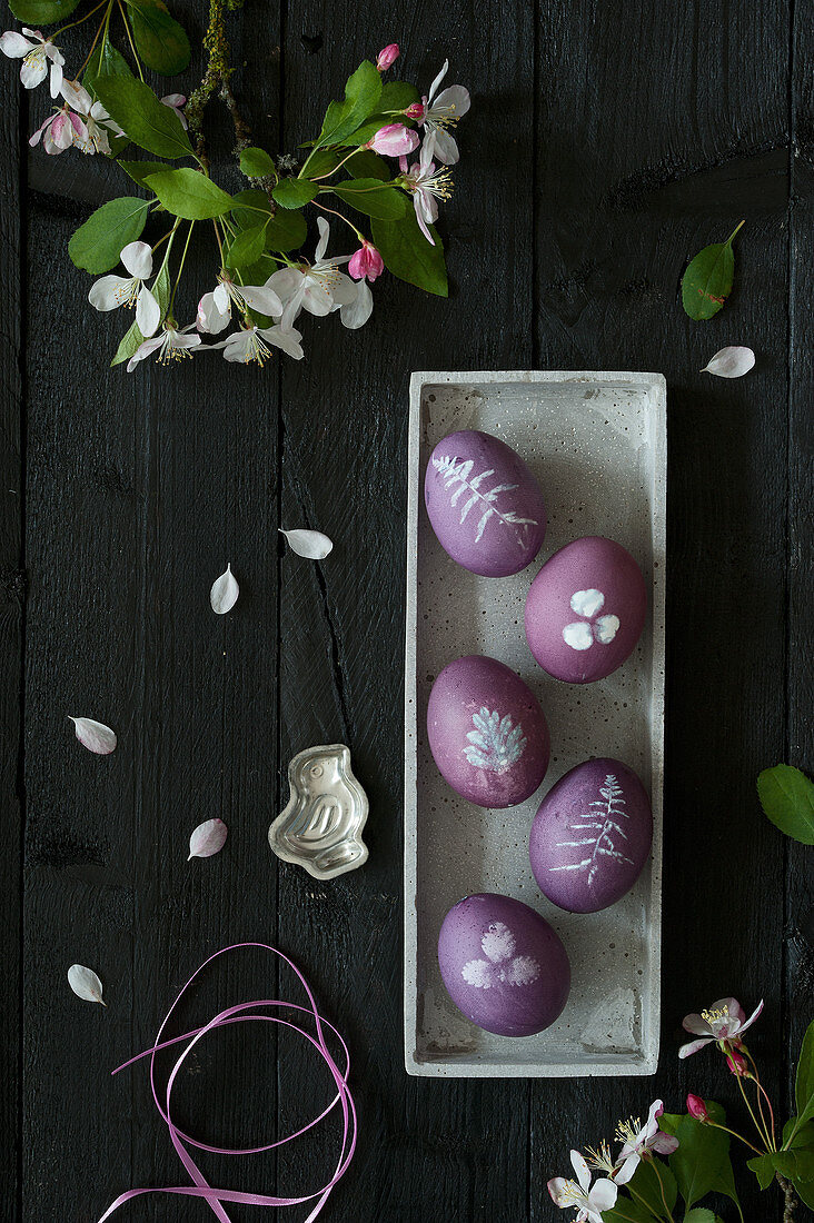 Dyed purple Easter eggs with botanical motifs