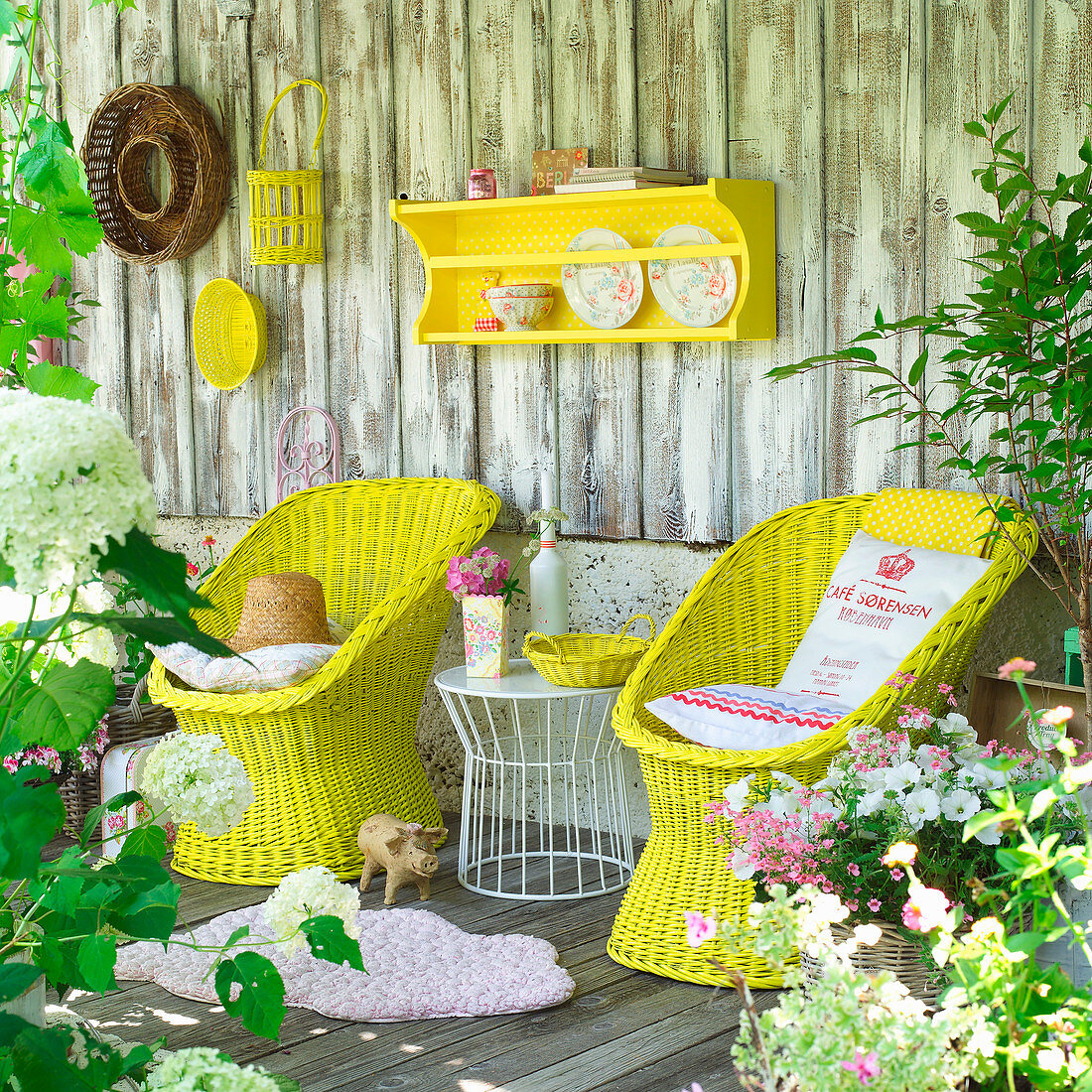 Yellow-painted wicker chairs and accessories on terrace