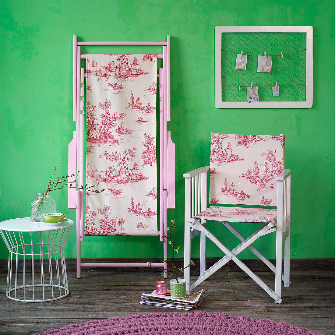 Folding chair with toile-de-jouy fabric seat and back in front of green wall