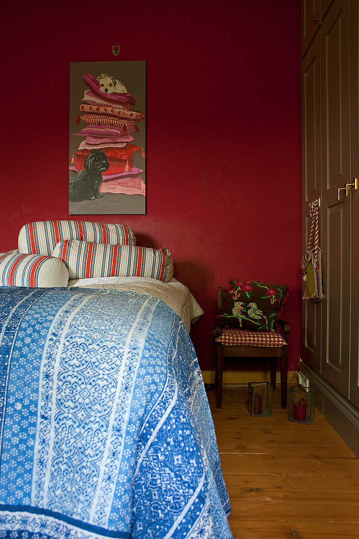 Bed in bedroom with red wall