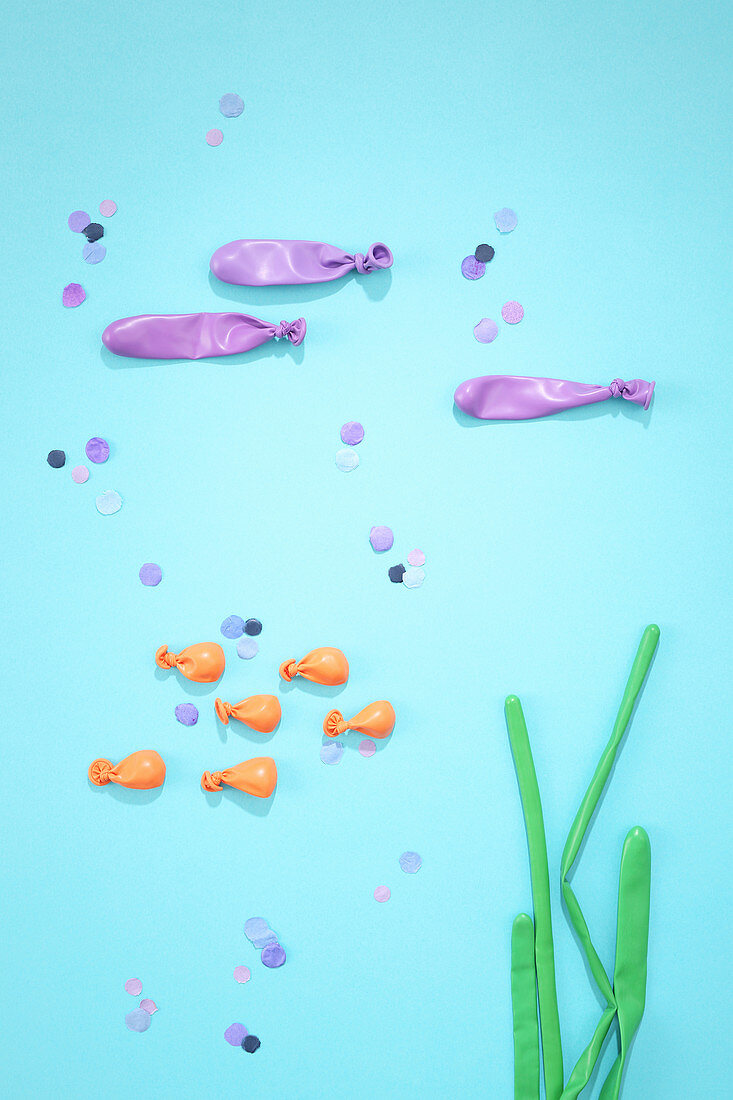 Underwater arrangement of balloons and confetti