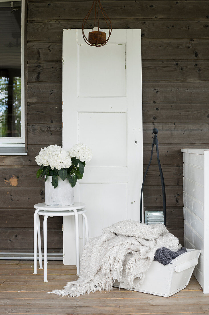 Old door and white accessories in country-house style on terrace