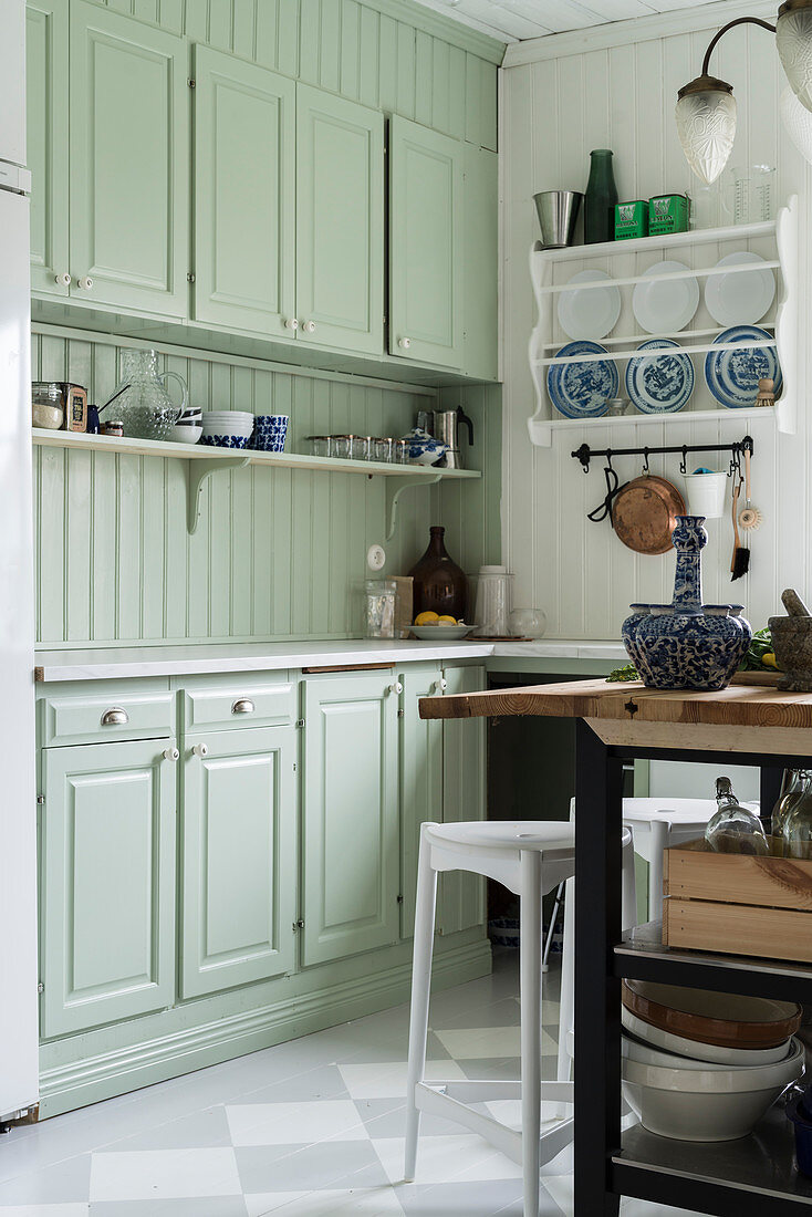Mint-green country-house kitchen with chequered floor