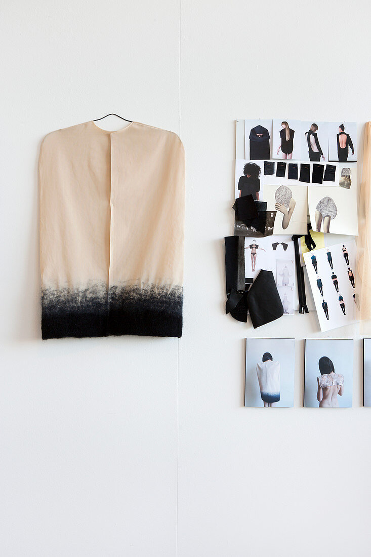 Collage of fashion designs and unusual top hanging on wall