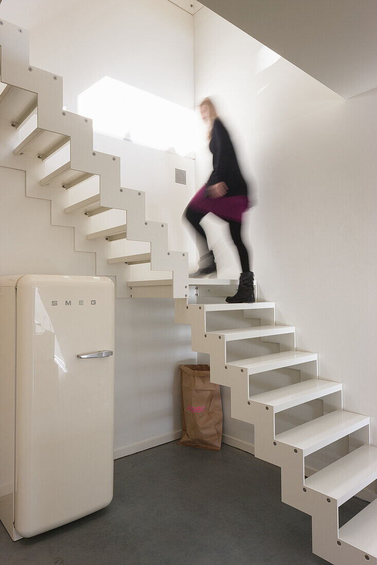 White lacquered space-saving staircase in modern interior