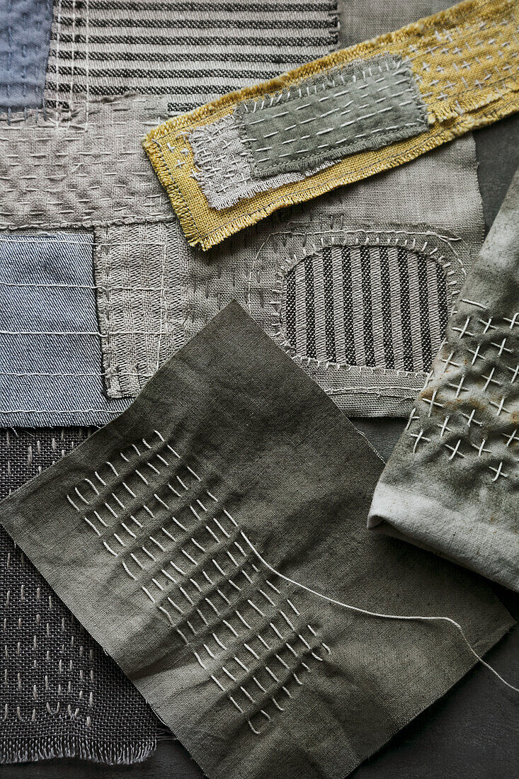 Hand-embroidered fabric samples with different patterns and textures