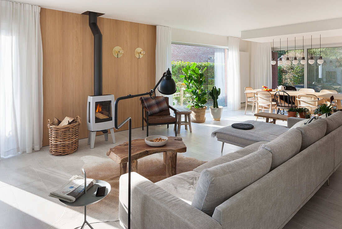 Bright living room with fireplace, wooden elements and dining area