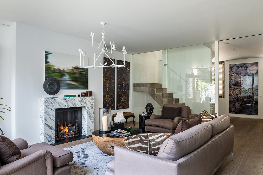 Exotic, eclectic mixture of styles in living room with marble fire surround
