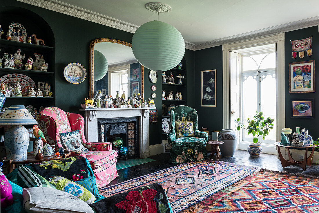 Eccentric living room with dark walls and colourful accessories
