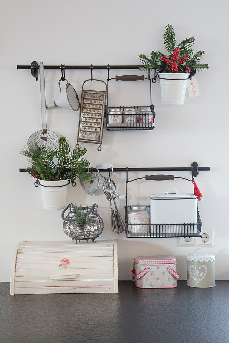 Christmas decorations on wall-mounted storage rails in kitchen