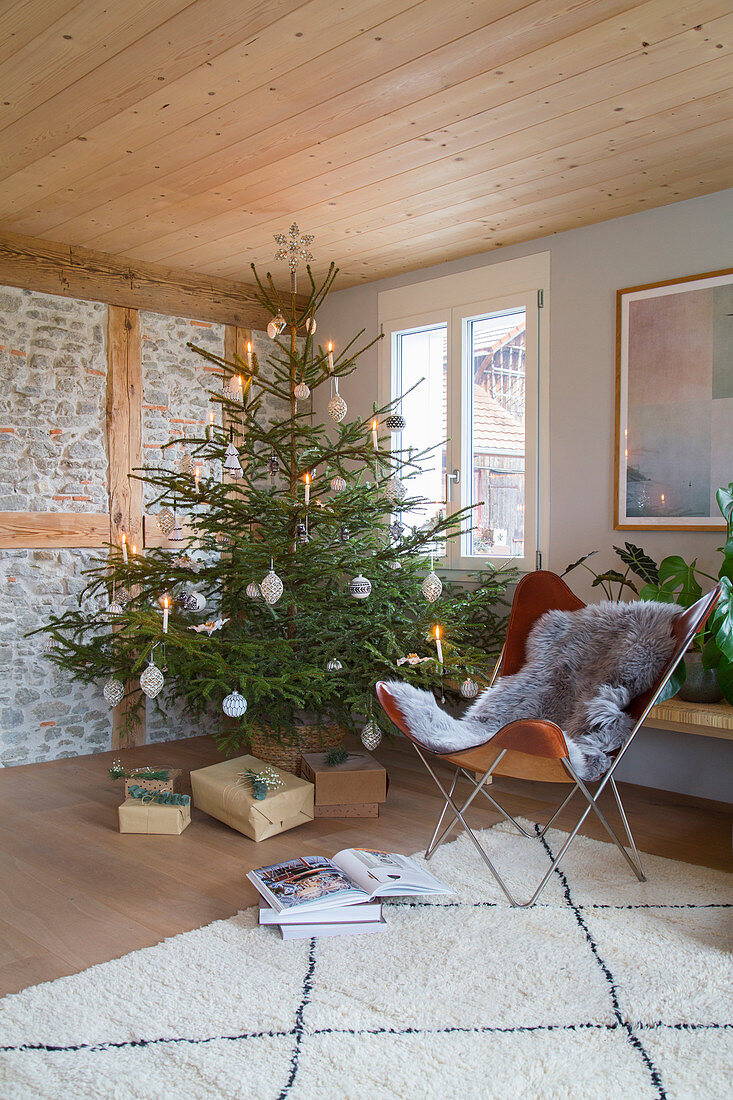 Simply decorated Christmas tree in rustic living room
