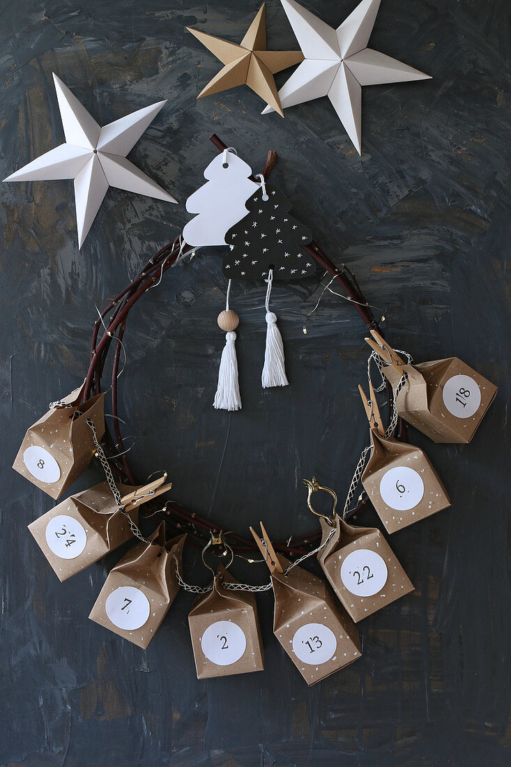 Handmade Advent calendar with numbered boxes made from brown paper threaded onto wreath