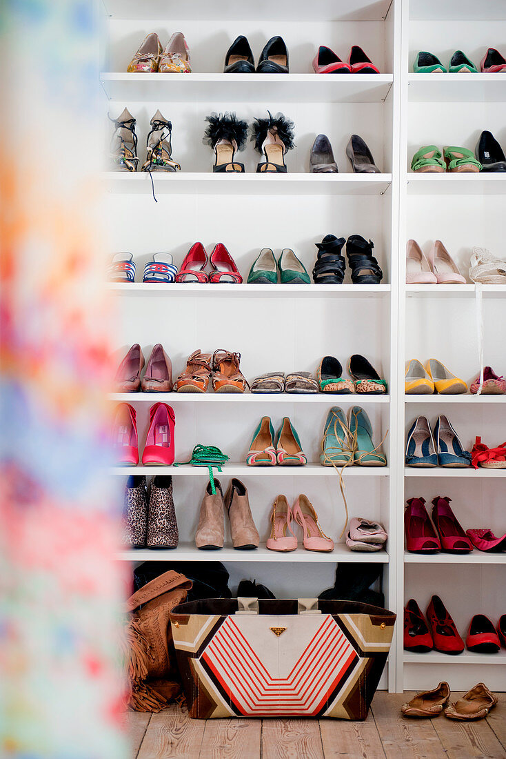 Ladies' summer shoes on white shelves