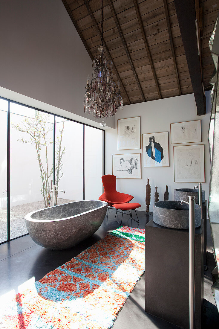 Free-standing, stone bathtub in artistic bathroom