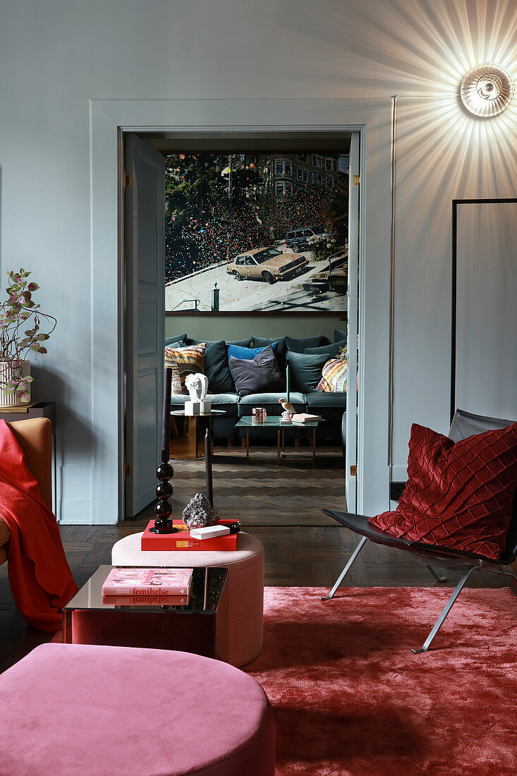 Glamorous living room in shades of red with view through open double doors