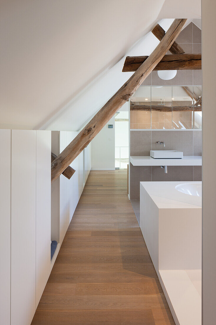 Attic bathroom with wooden beams and modern sink