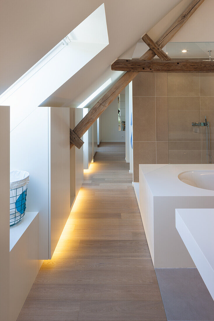 Attic bathroom with wooden beams, shower and sink