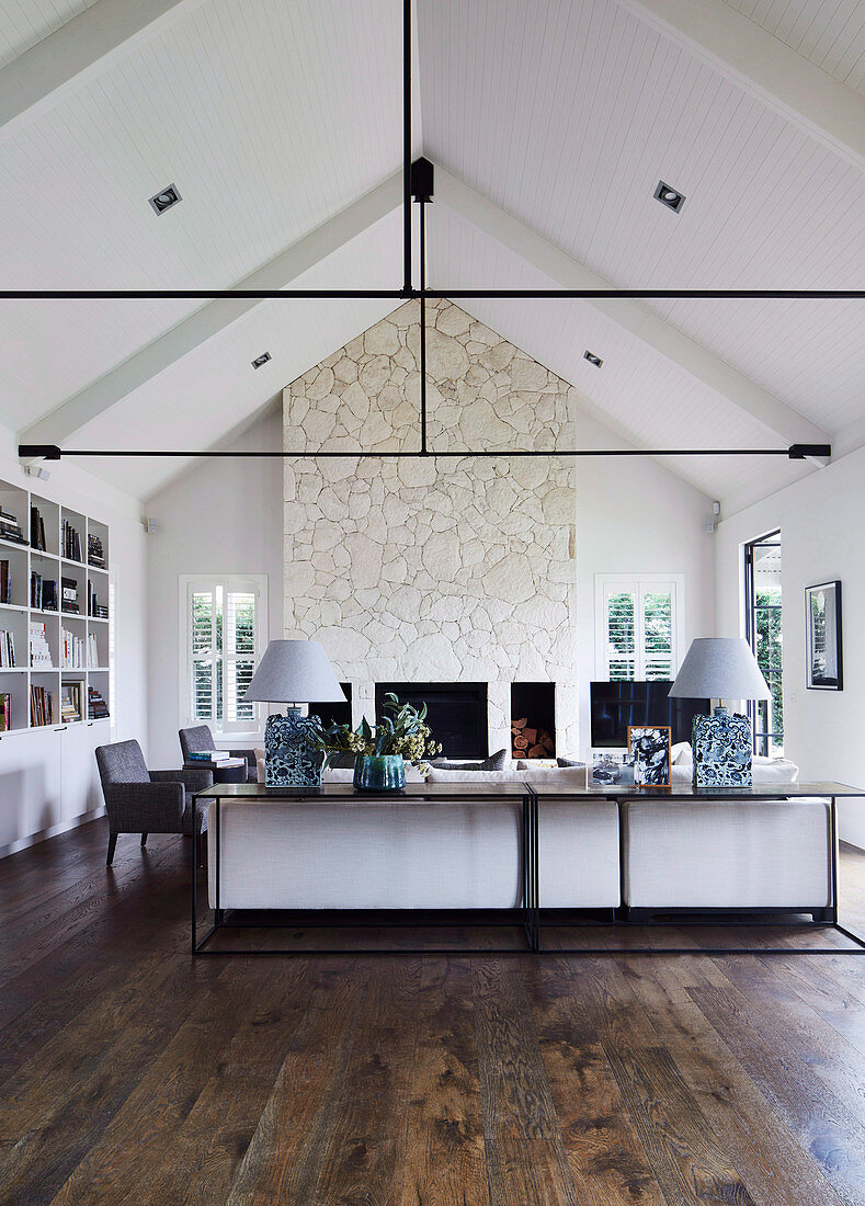 Modern, classic living room with open ceiling and steel beams