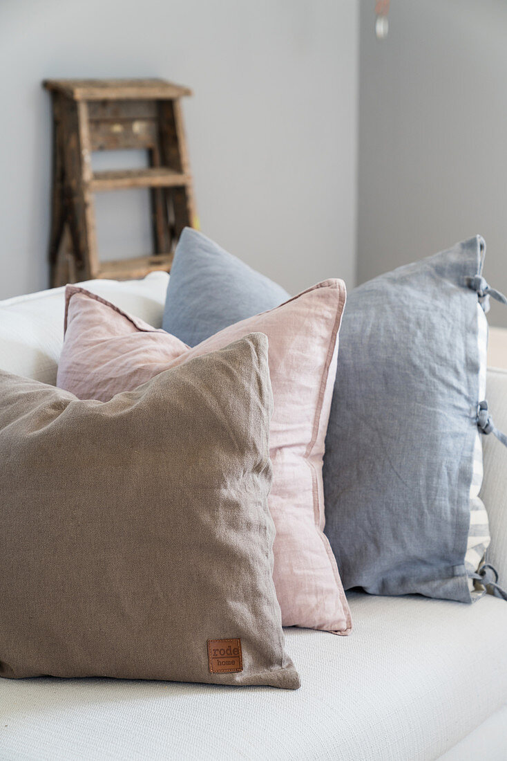 Linen scatter cushions in pastel shades on sofa