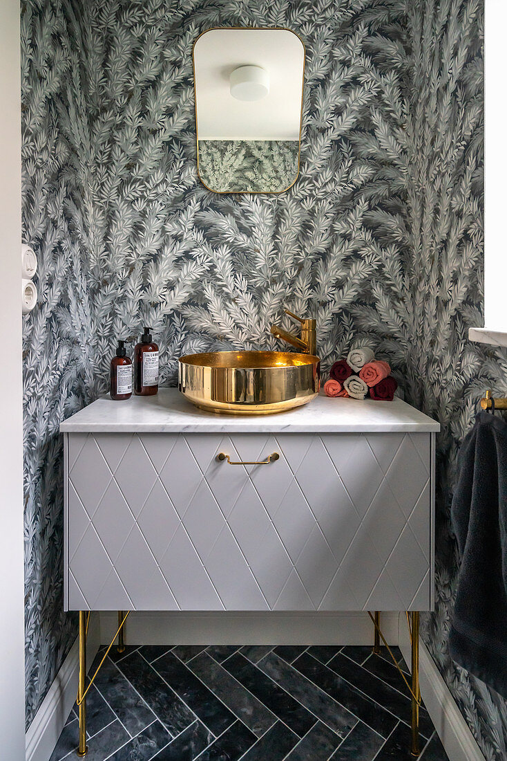 Washstand with modern sink in bathroom with grey patterned wallpaper