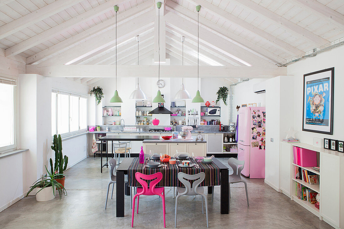 Open roof structure in bright loft apartment with hot pink and pale pink accents