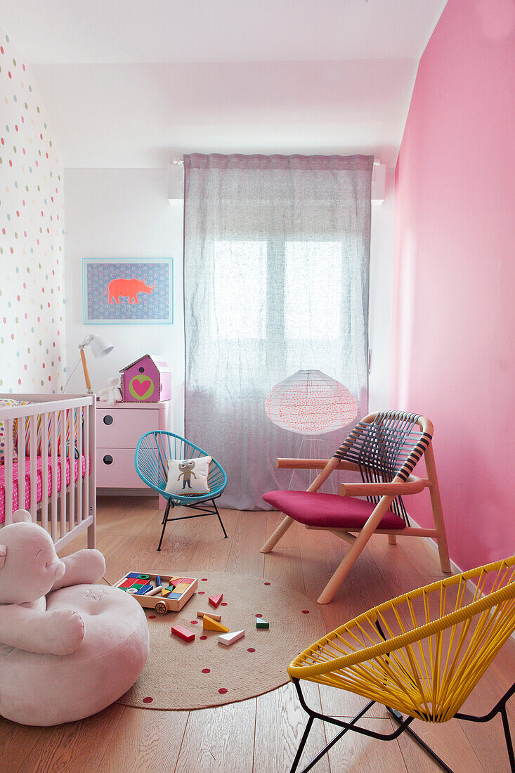 Various armchairs in pink nursery