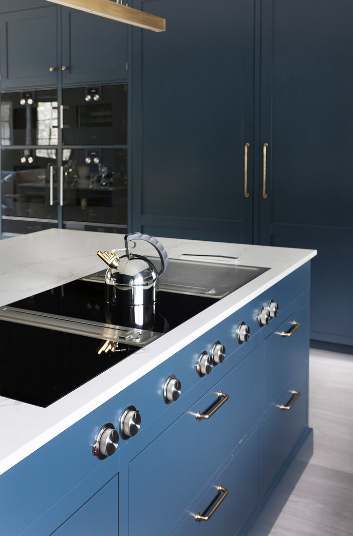 Modern hob on island counter in classic, blue-grey kitchen