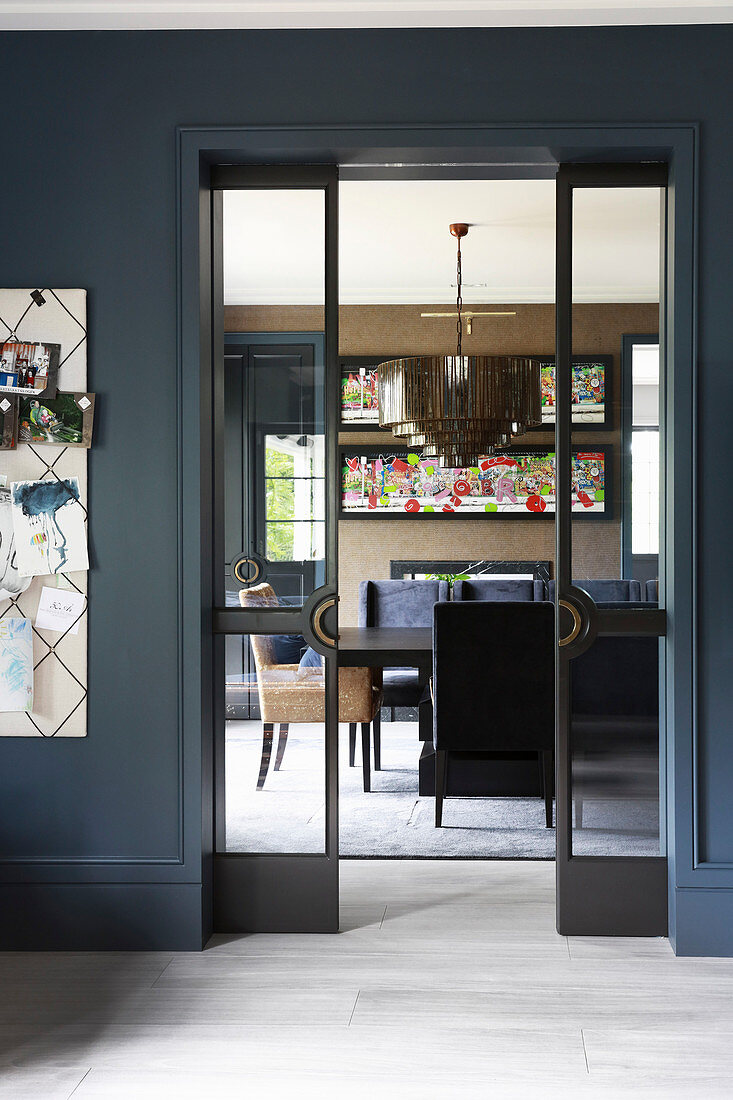 View into elegant dining room through open, glass sliding doors