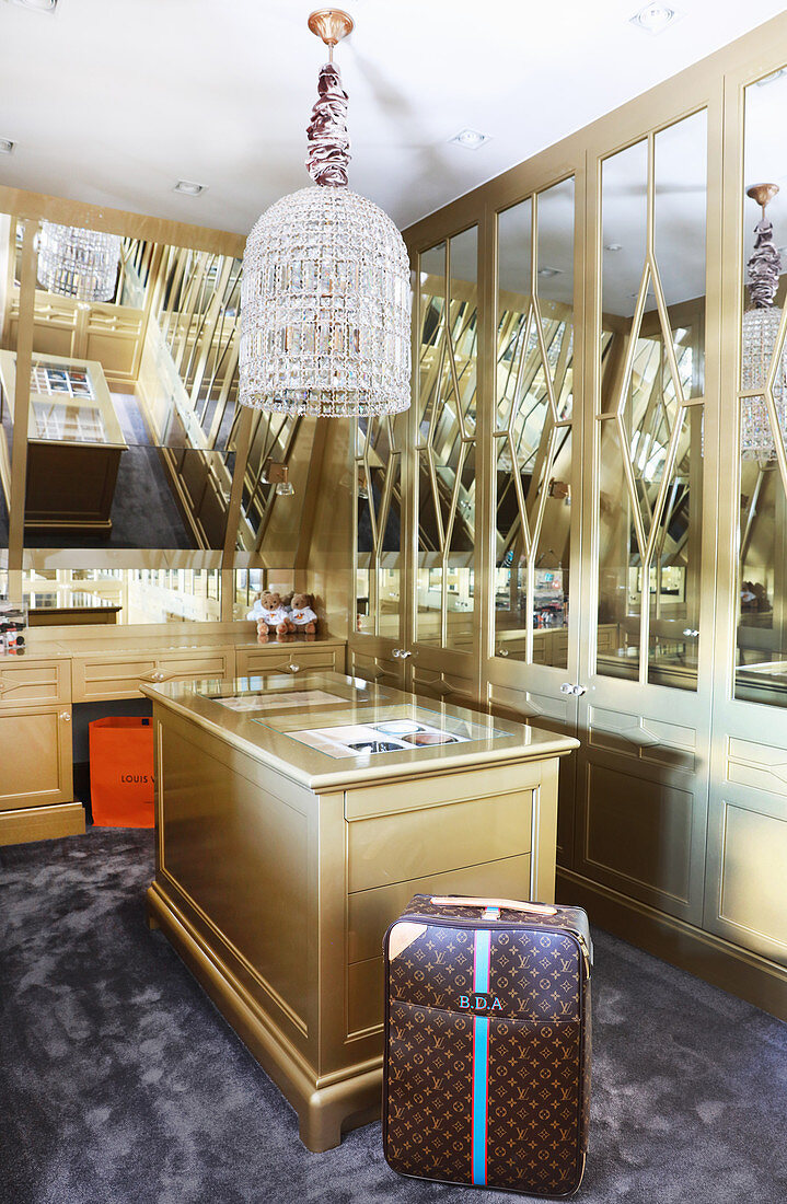 Golden fitted cupboards in luxurious dressing room
