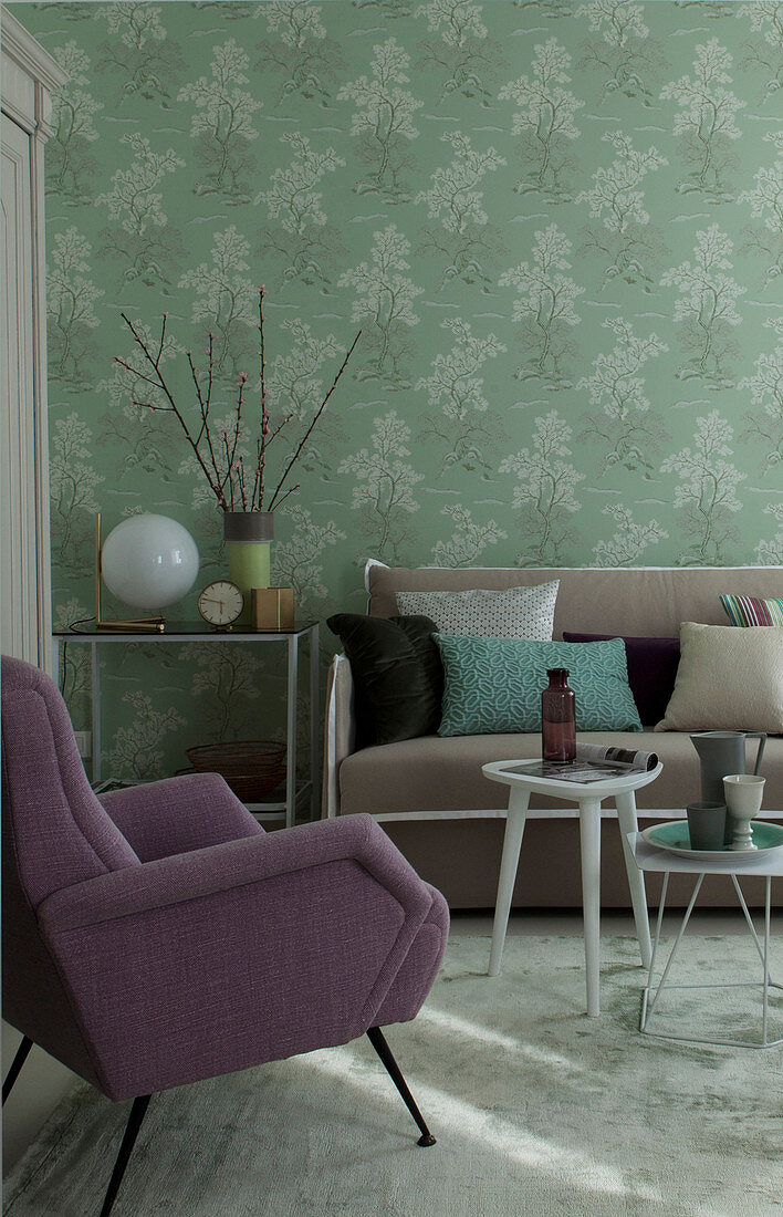 Upholstered furniture in living room with green wallpaper